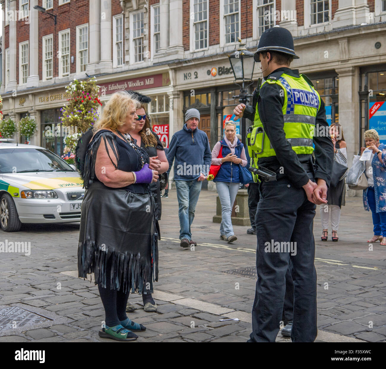 Ladies dressed up for a hen party asking a Policeman directions Stock Photo