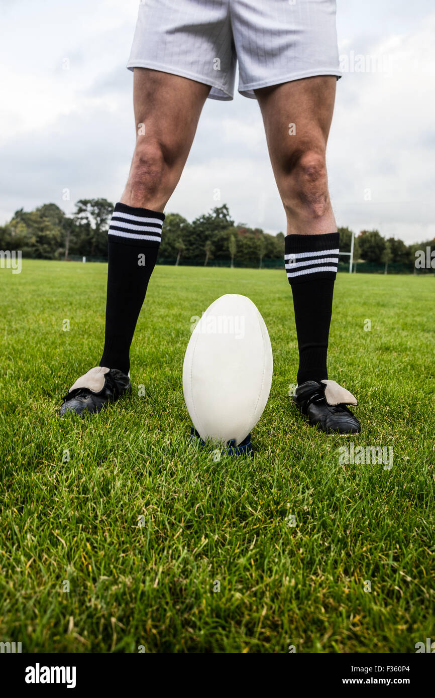 Rugby player about to kick ball Stock Photo