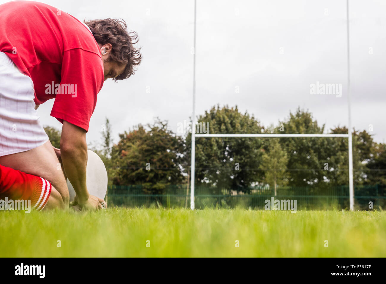 Rugby player getting ready to kick ball Stock Photo Alamy