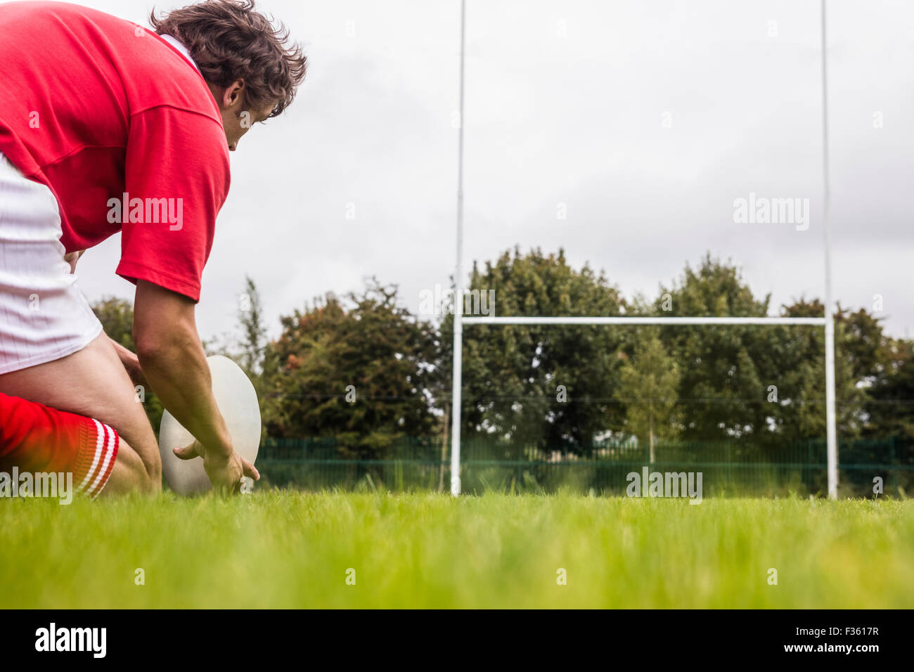 Rugby player getting ready to kick ball Stock Photo Alamy