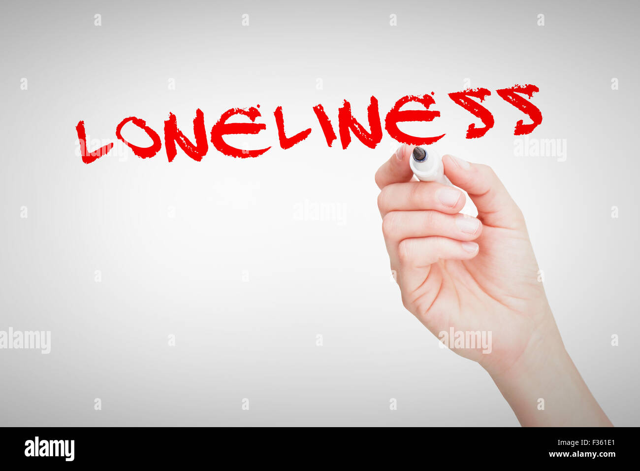 Loneliness against female hand holding black whiteboard marker Stock Photo