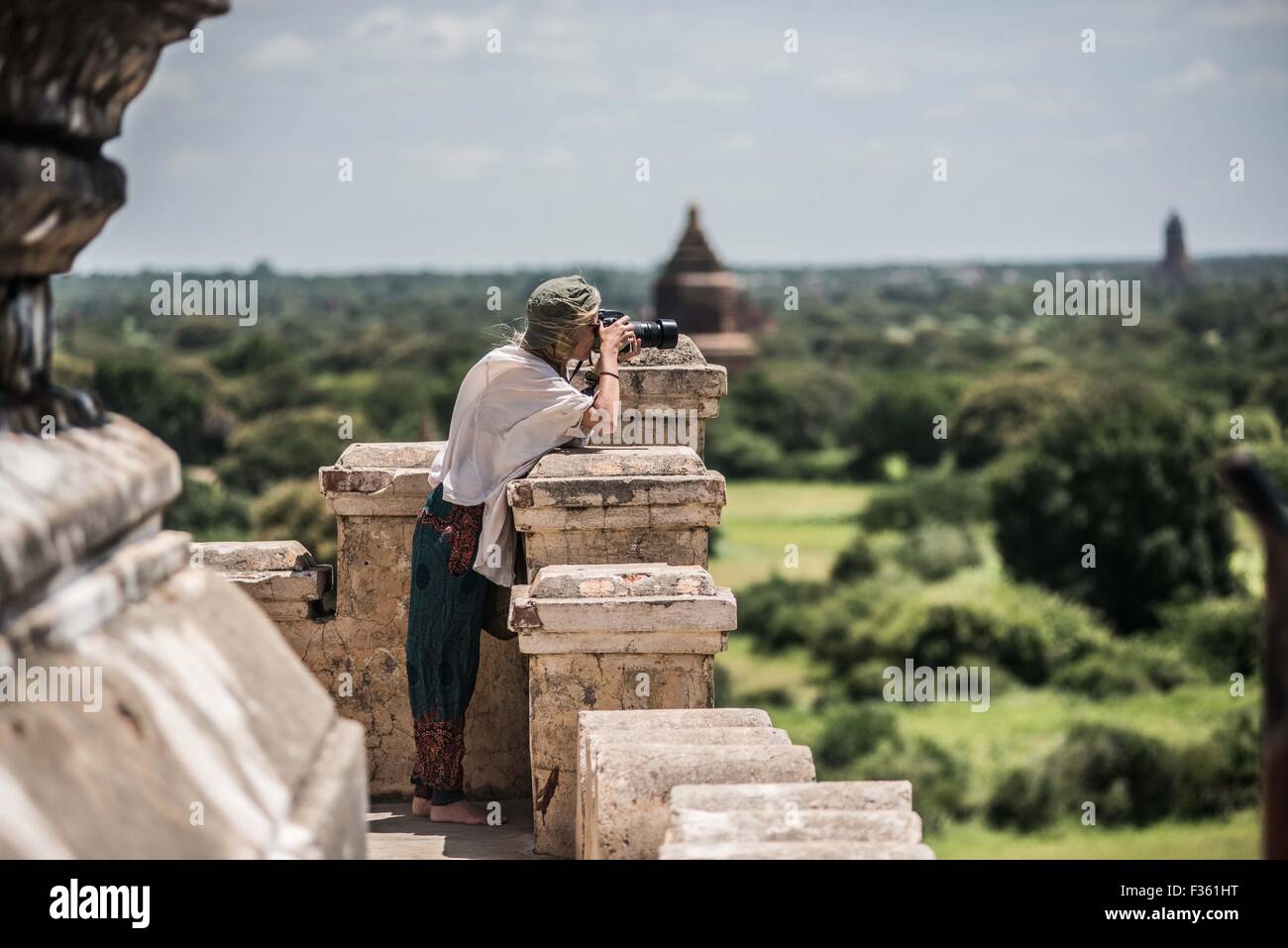 A traveler takes pictures of temples in Bagan, Myanmar Stock Photo