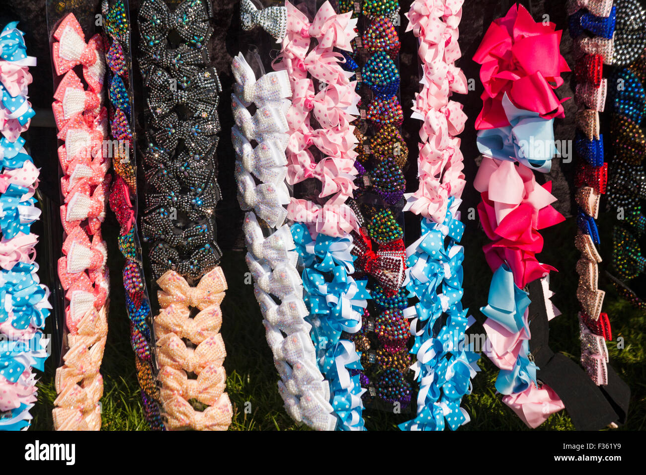 Bow ties or hair decorations on display rack for sale on stall at Poole