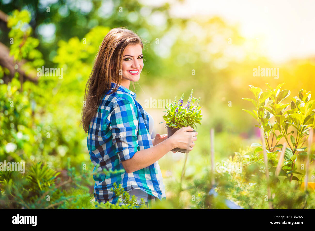 Beautiful young woman gardening Stock Photo - Alamy