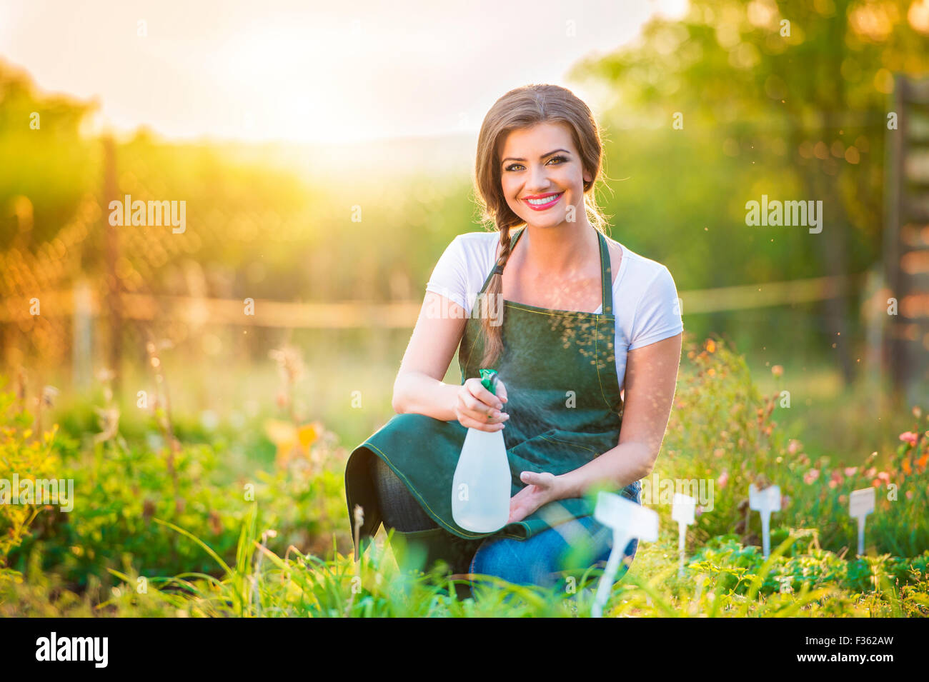 Beautiful young woman gardening Stock Photo - Alamy