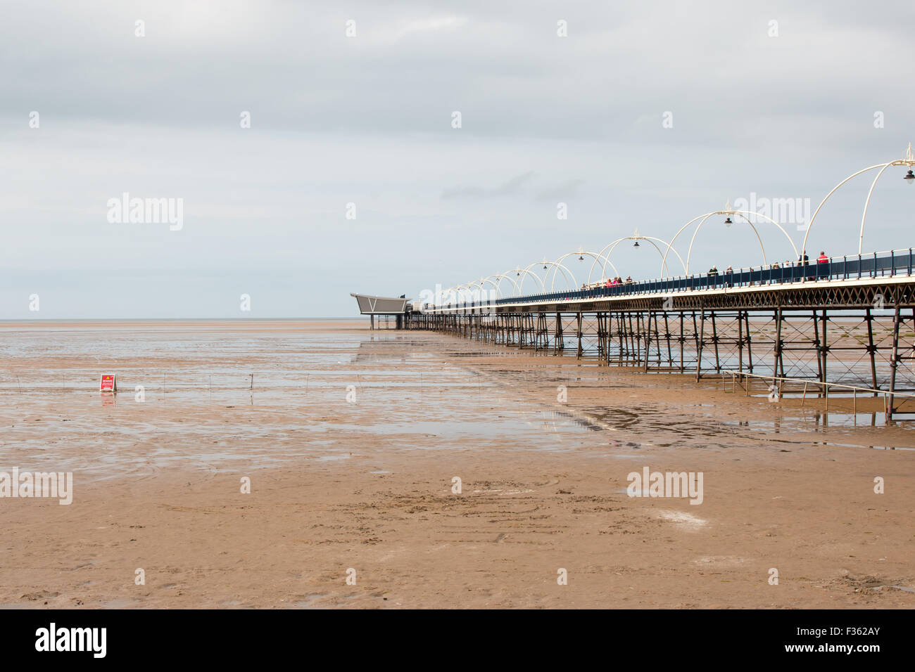 Southport Pier and overcast weather. People walking on the pier Stock