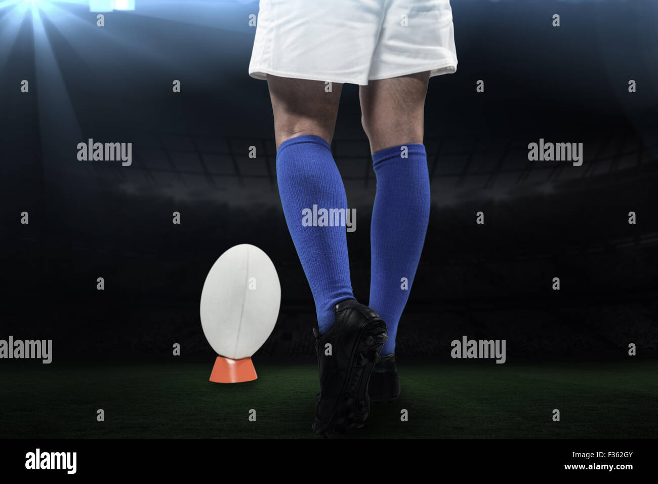 Composite image of low section of rugby player going to kick the ball
