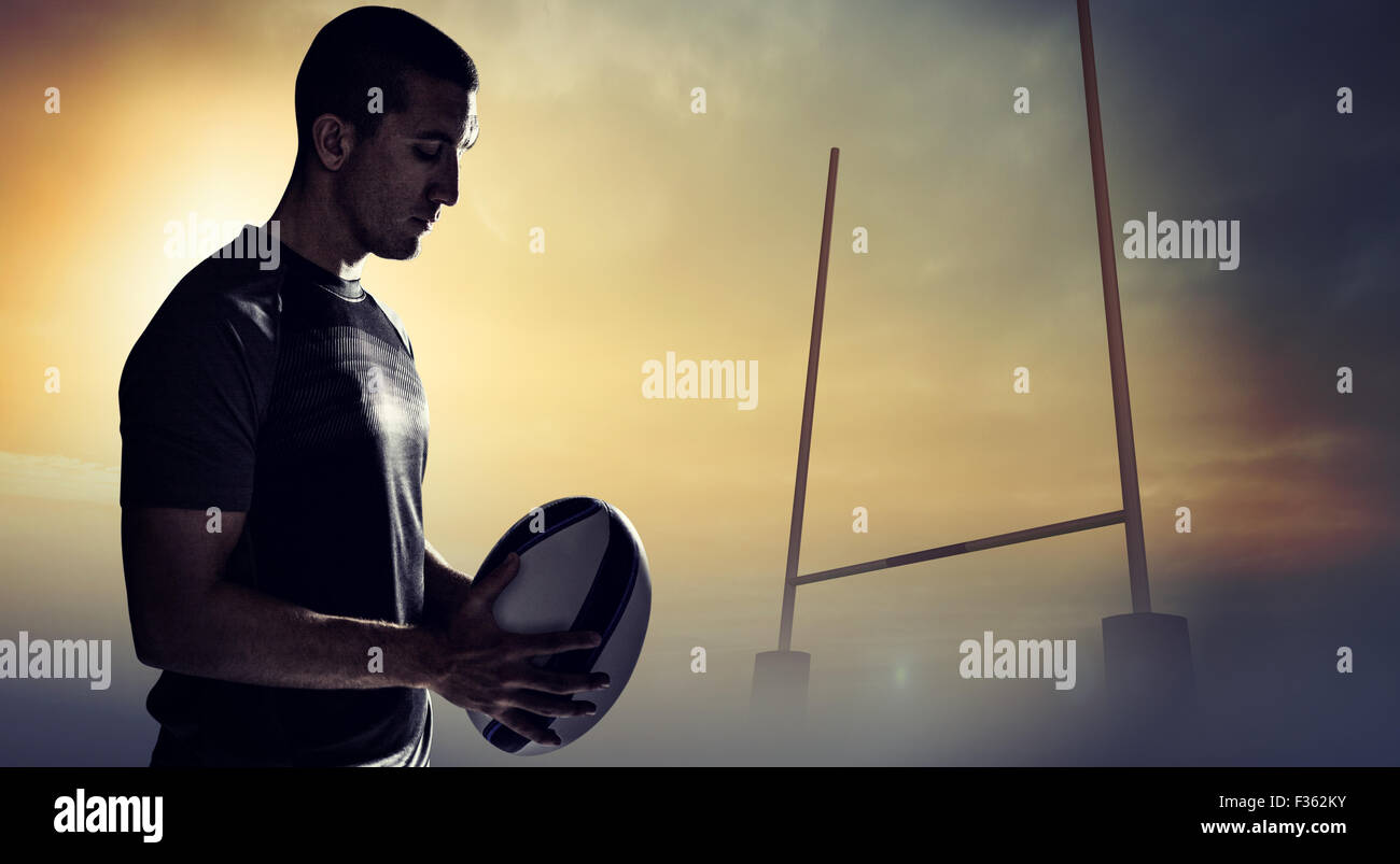 Composite image of calm rugby player thinking while holding ball Stock ...
