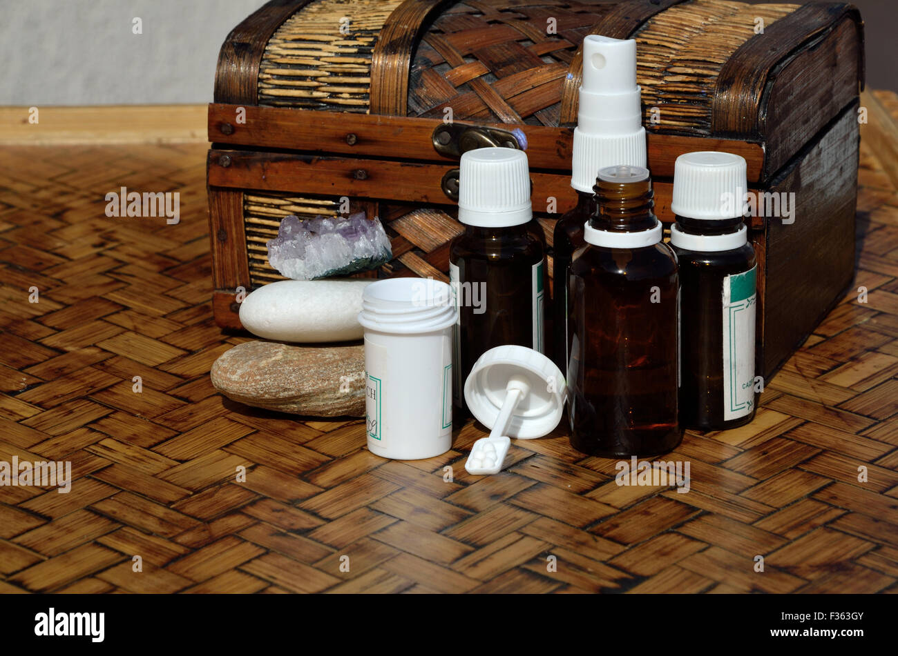 Chest, bottles and containers of homeopathic remedies and stones Stock Photo