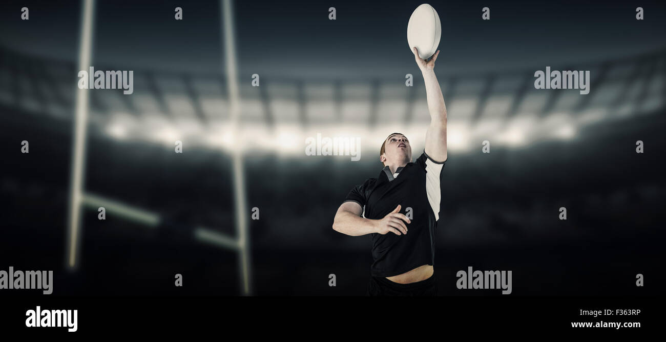 Composite image of rugby player catching a rugby ball Stock Photo - Alamy