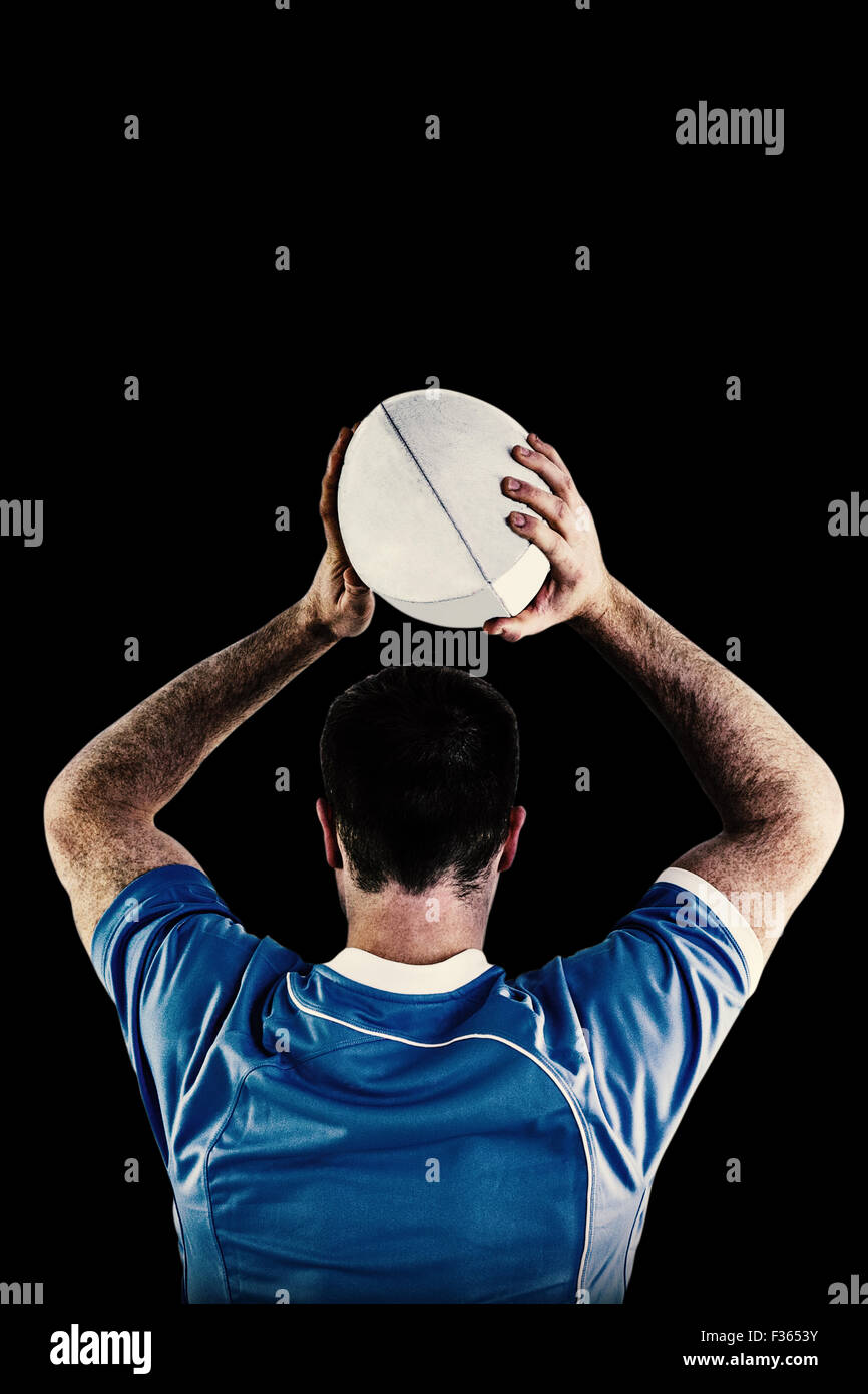 Composite image of rugby player about to throw a rugby ball Stock Photo