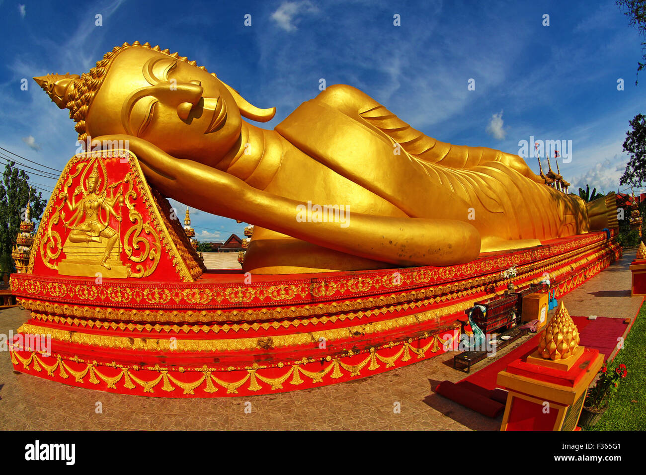 Giant gold reclining sleeping Buddha statue near Wat That Luang Temple