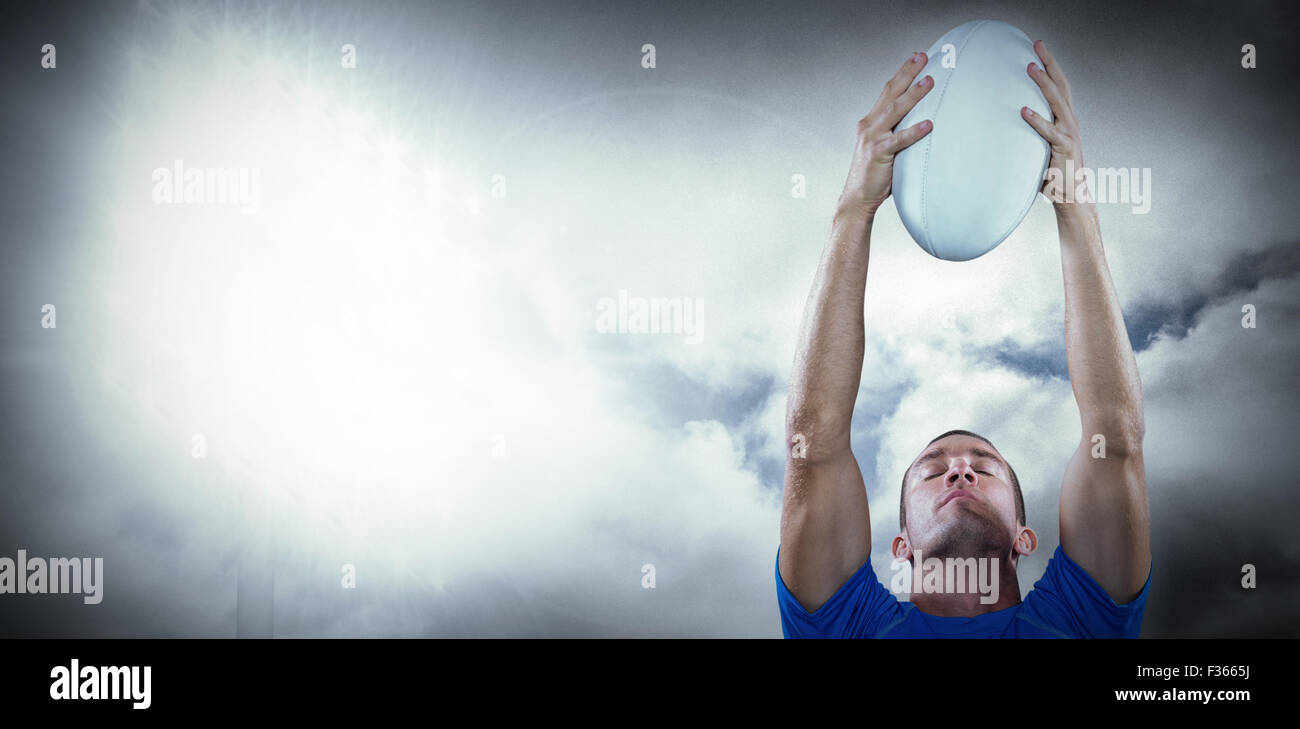 Composite image of rugby player holding ball with eyes closed Stock Photo Alamy