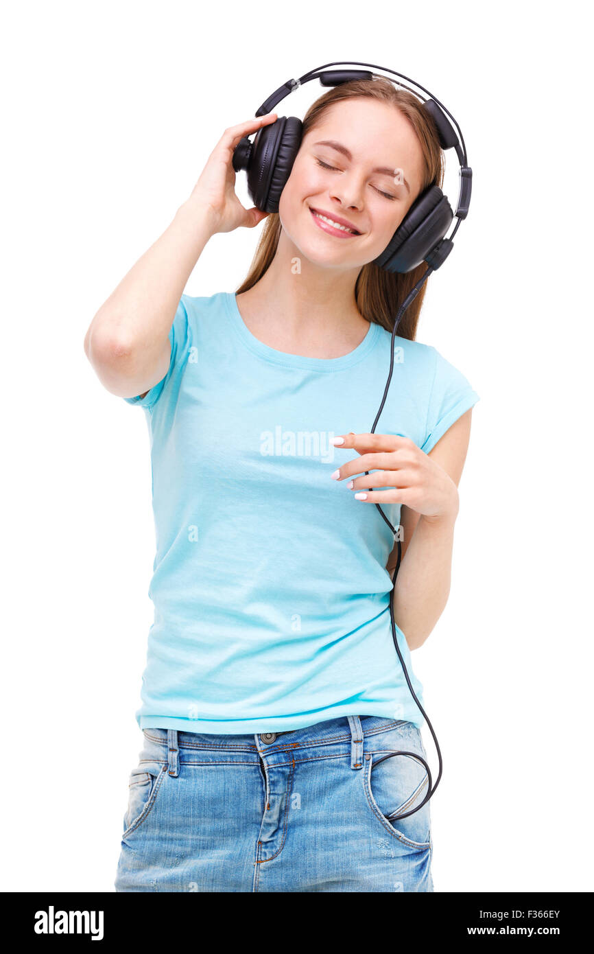 Young woman with headphones listening to music and dancing - isolated ...
