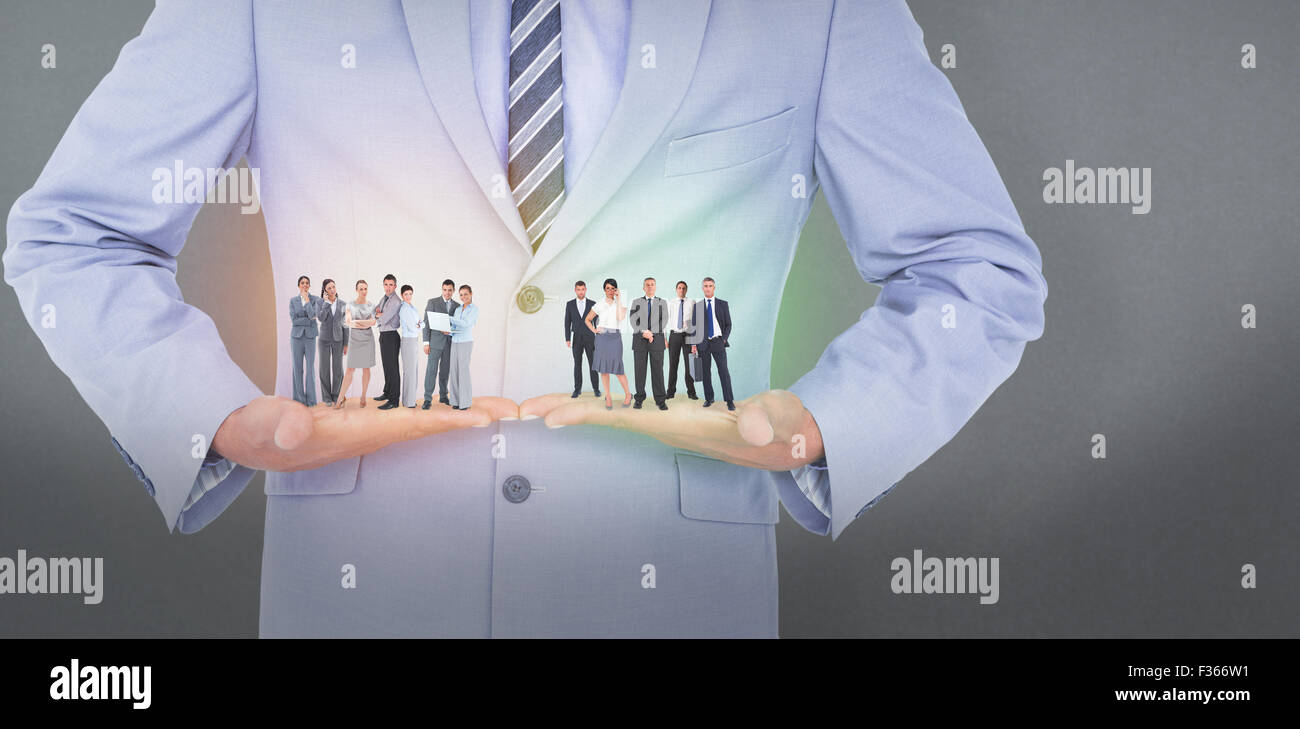 Composite image of business team looking at camera Stock Photo - Alamy
