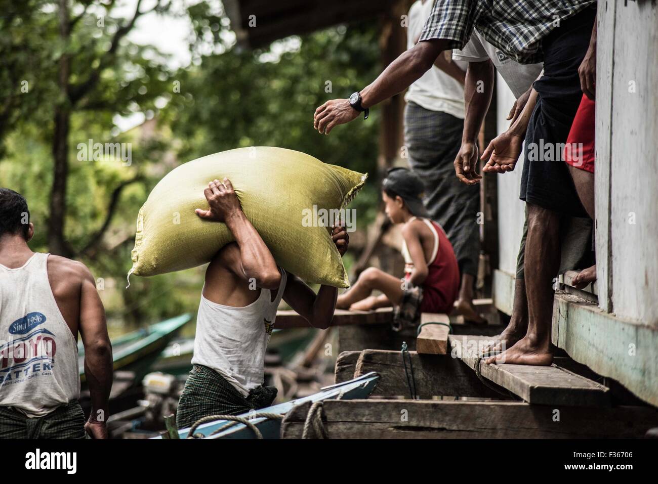 Humanitarian aid supplies are delivered by an NGO to flood hit communities in Myanmar's Irrawaddy delta region. Stock Photo