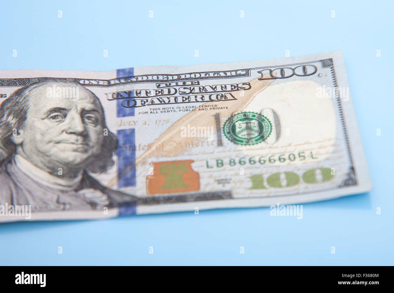 Single hundred dollar note. All on blue background Stock Photo