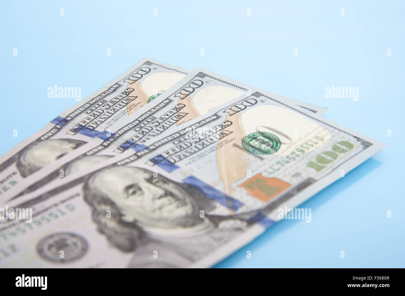 Three hundred dollar notes. All on blue background Stock Photo