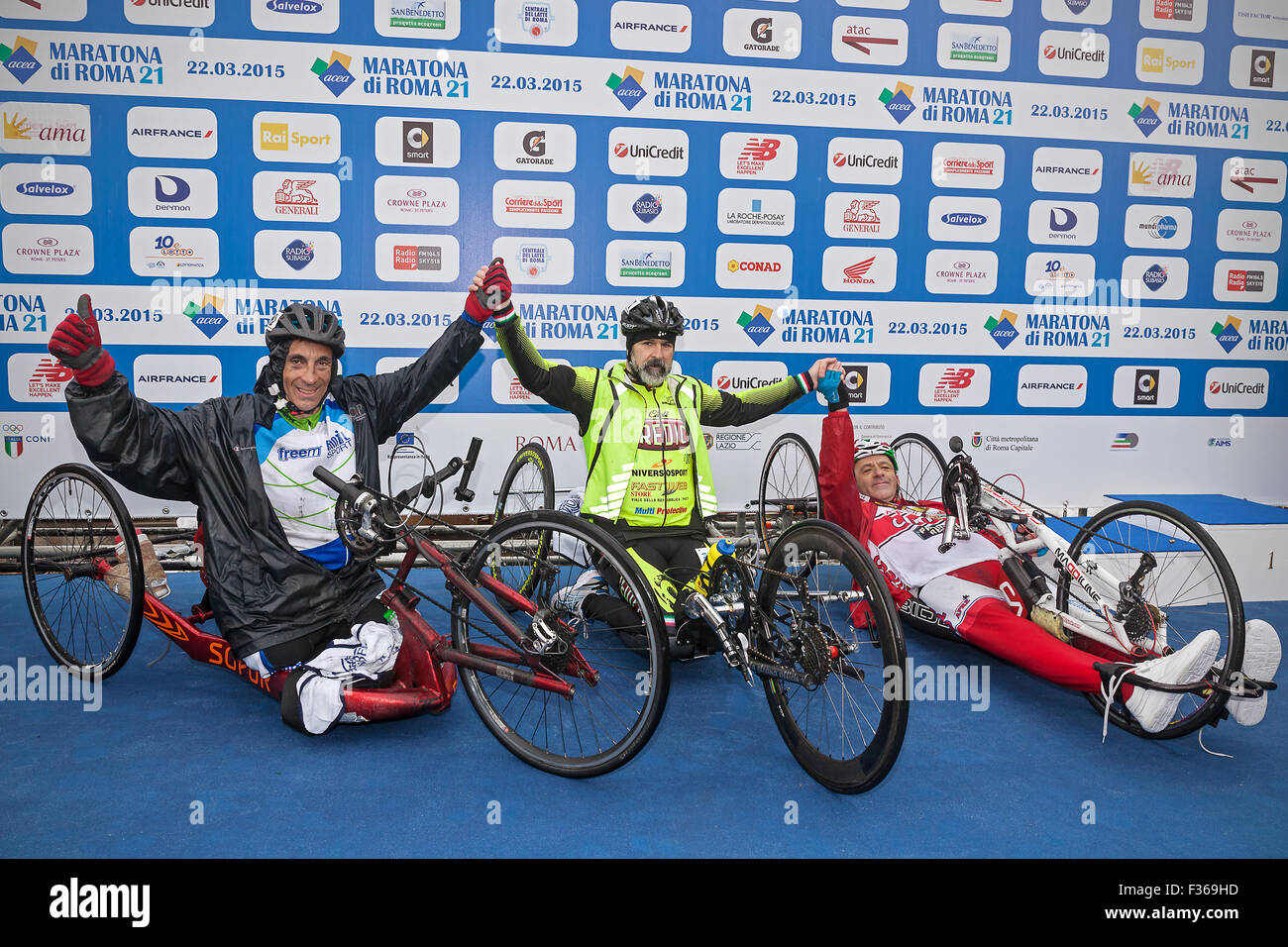 Rome, Italy - March 22, 2015: 21th Rome Marathon. Winner of the race handbike Fabrizio Caselli (center), with (to his right) runner Fabrizio Bove, and (to his left) Gian Luca Laghi. Stock Photo