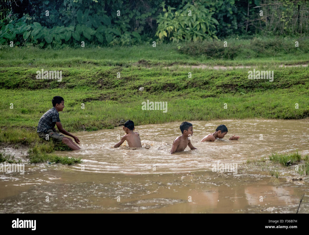 Playing in a puddle, Myanmar Stock Photo