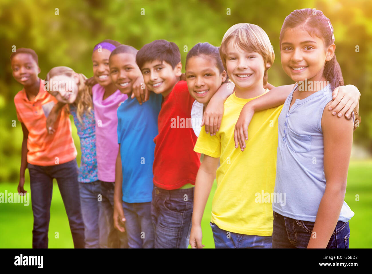 Composite image of happy friends in the park Stock Photo