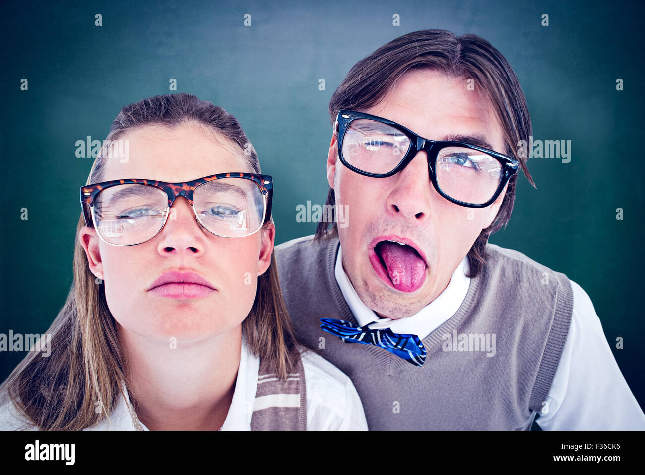 Composite image of funny geeky hipsters grimacing Stock Photo