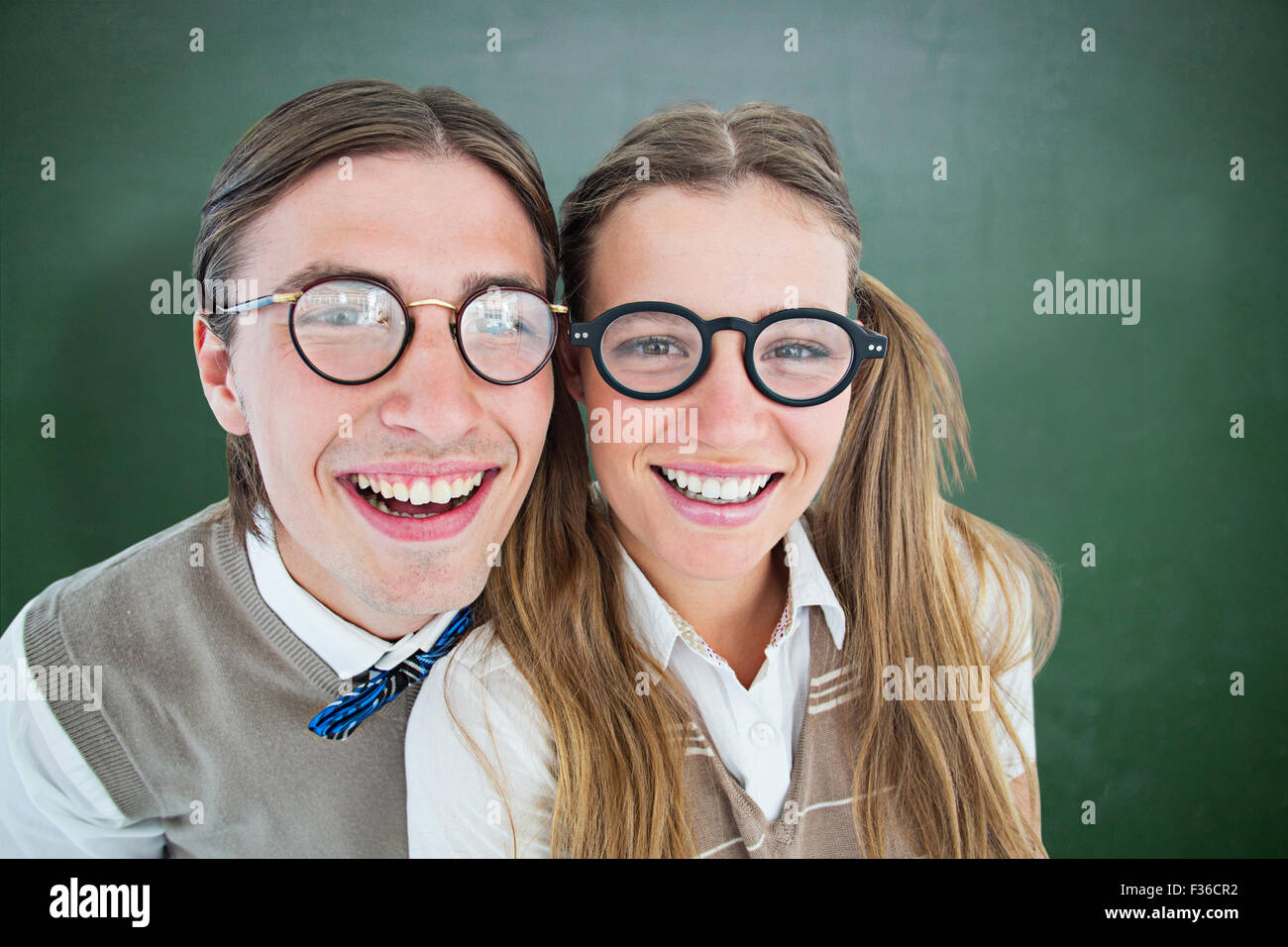 Composite image of geeky hipsters smiling at camera Stock Photo