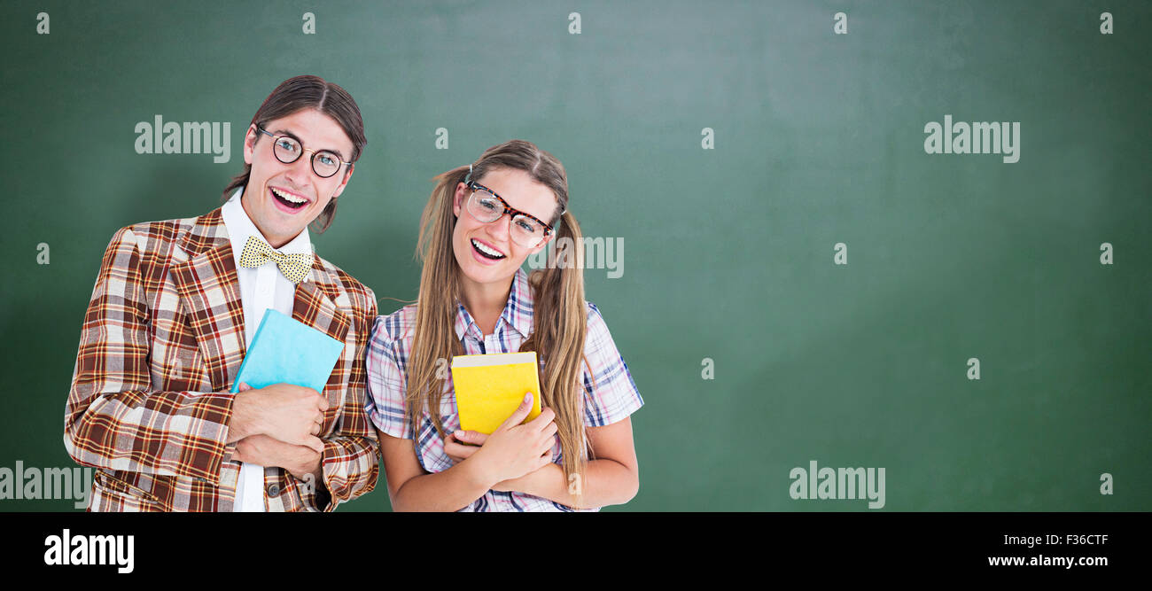 Composite image of geeky hipsters smiling at camera Stock Photo