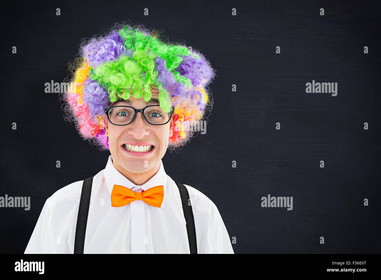 Composite image of geeky hipster wearing a rainbow wig Stock Photo