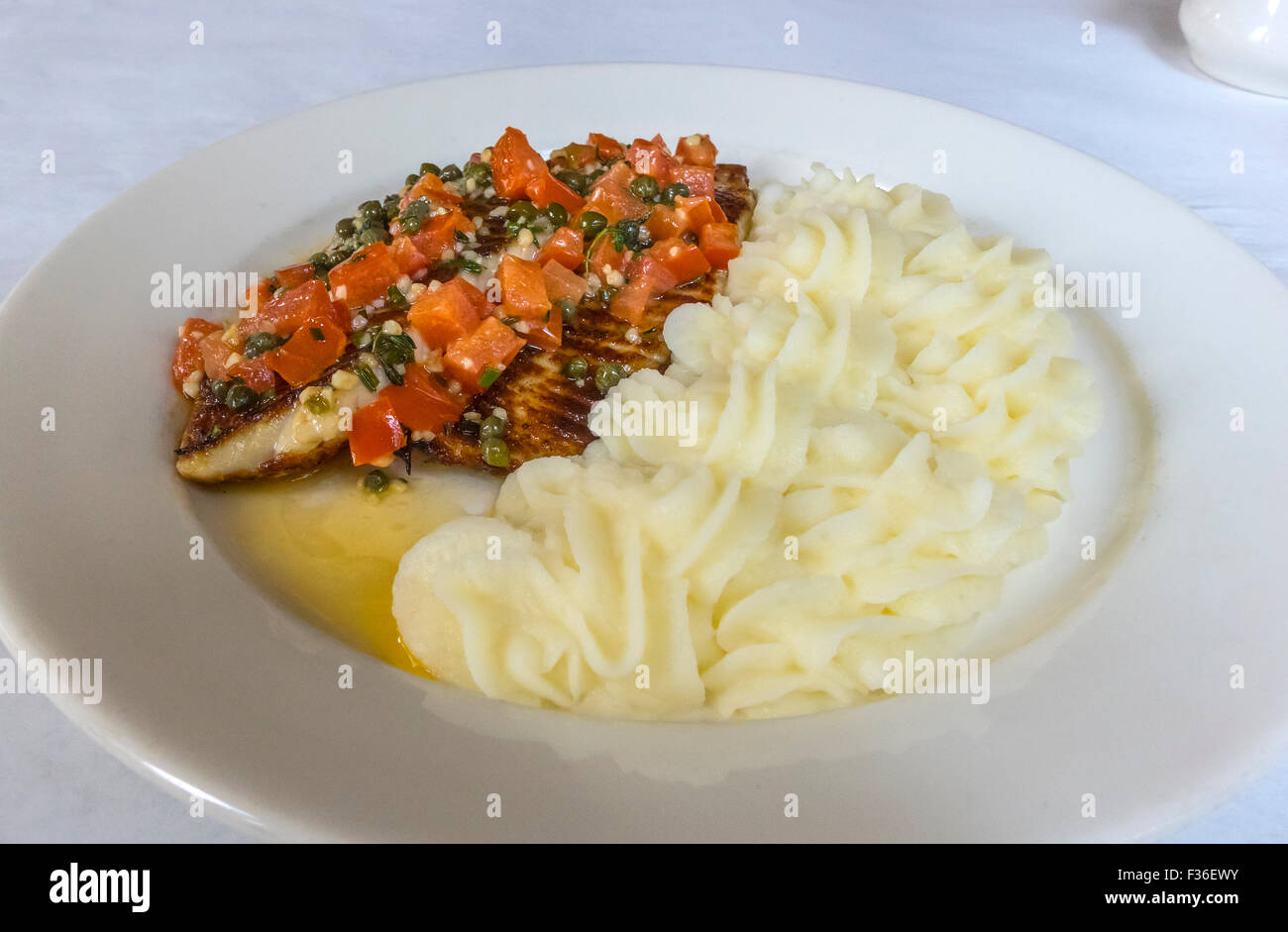 Grilled Tilapia with a sauce of tomato, capers, butter and quinoa and