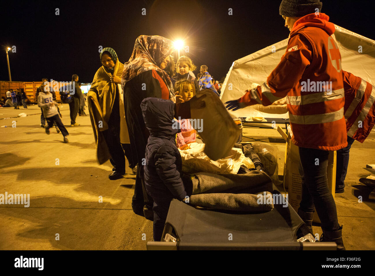 Refugees receives blankets from the Austrian red cross at the border crossing near Nickelsdorf on the Hungarian - Austrian border Stock Photo