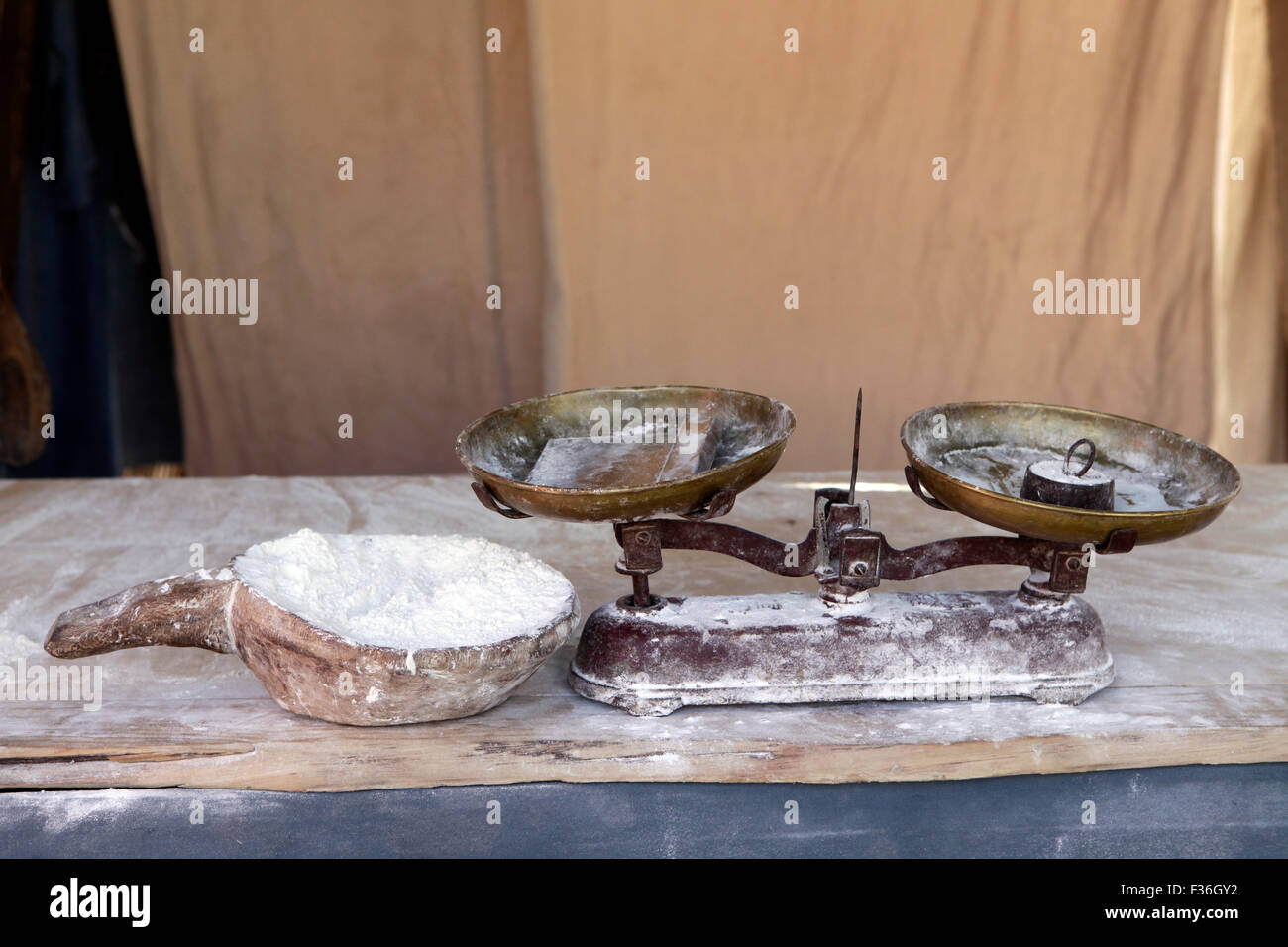 Old scale with flour used to bake bread. Medieval market in Montblanc, Tarragona, Catalonia, Spain. Stock Photo