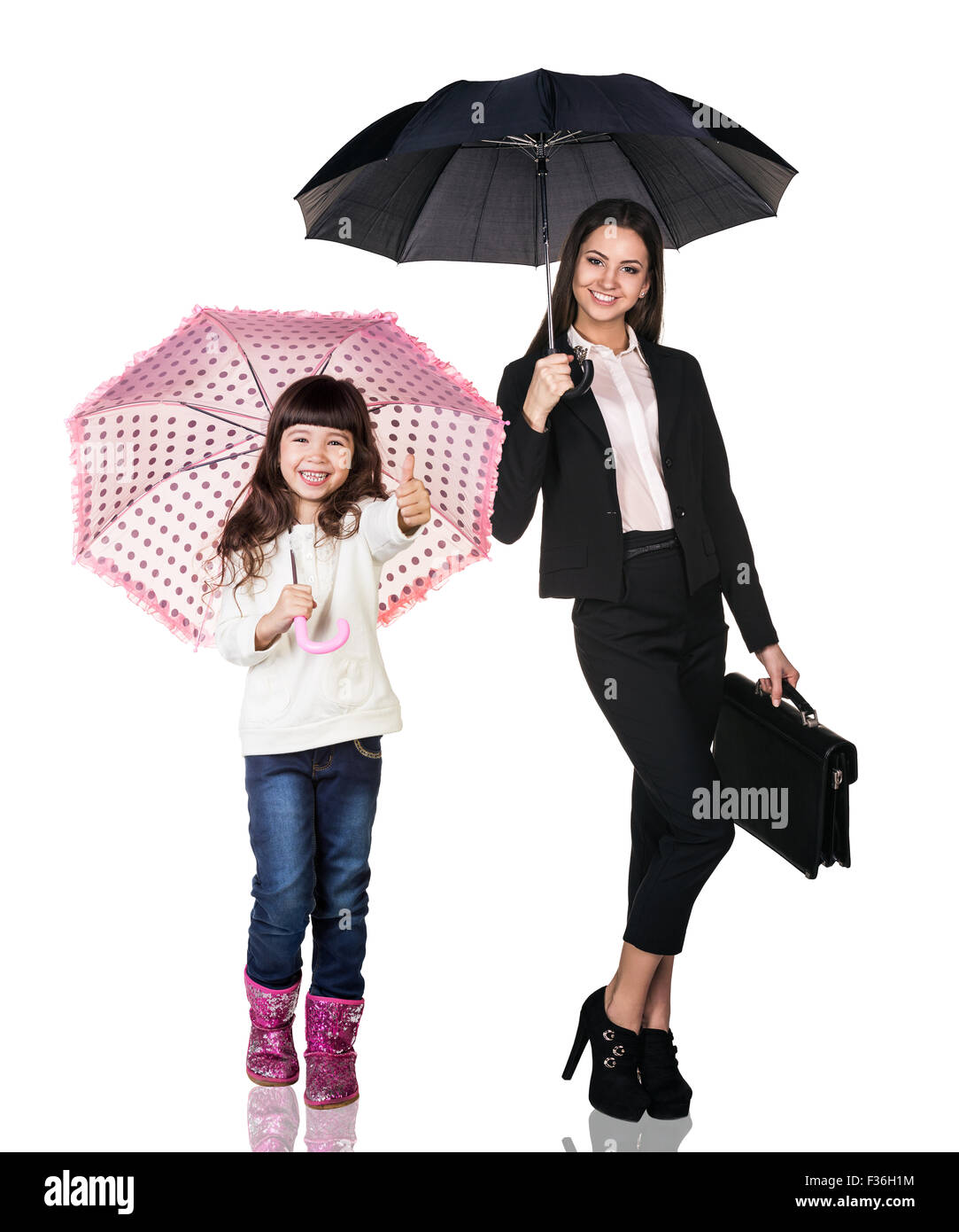Businesswoman with daughter under umbrellas Stock Photo