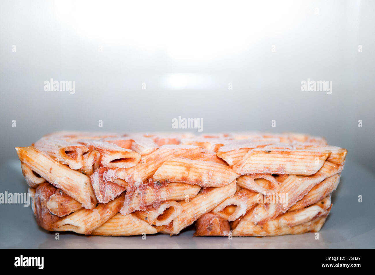 Frozen pasta meal ready for microwave cooking, still in the shape of the carton Stock Photo