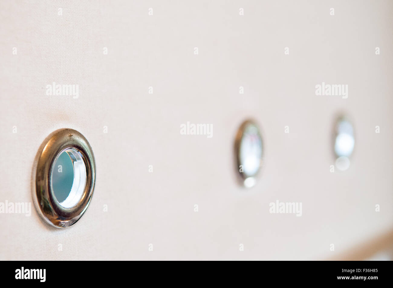Plain coloured material background with three rings at the base Stock Photo