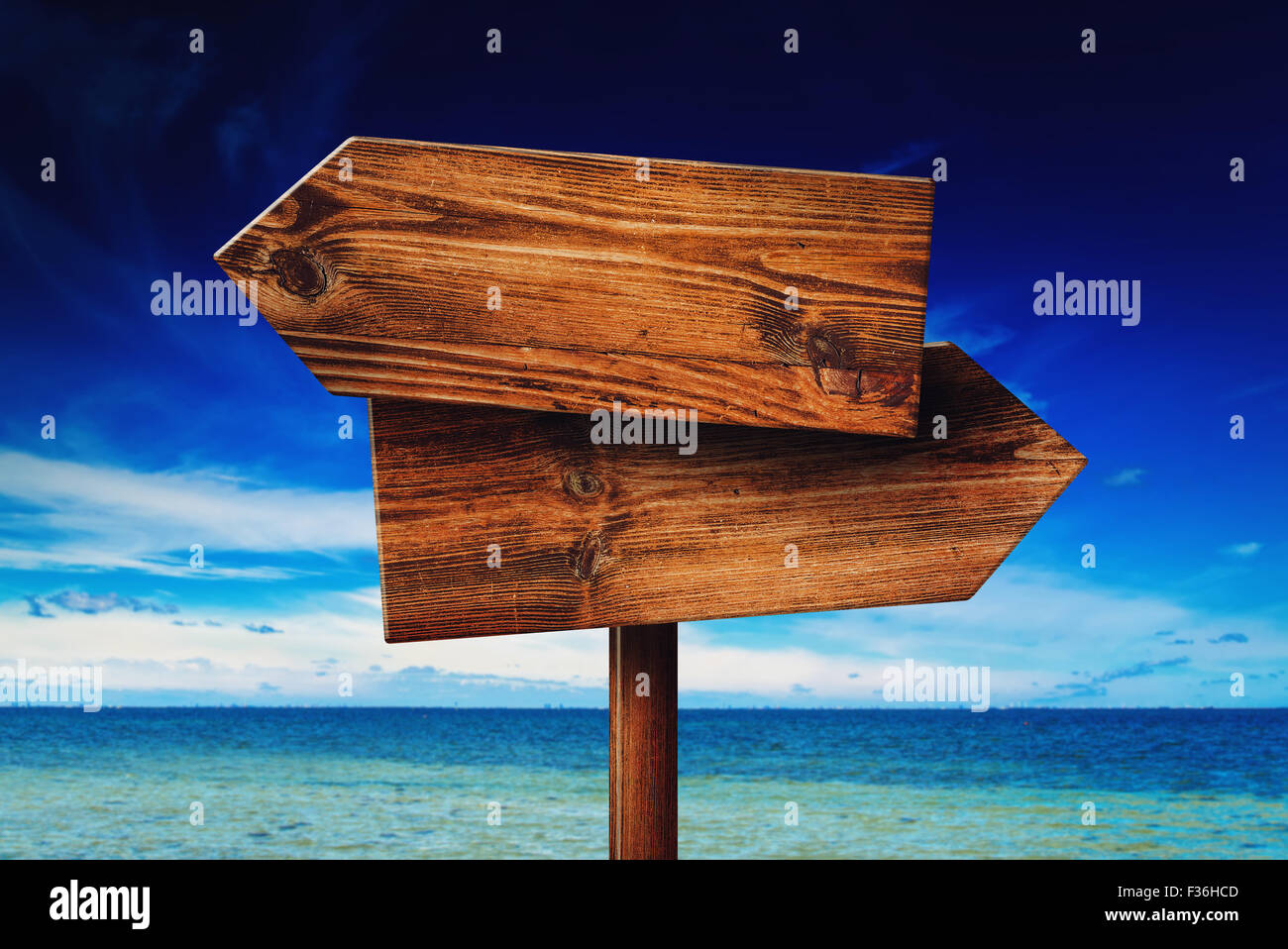 Direction signpost on seaside beach, rustic wooden blank sign in summer vacation resort Stock Photo