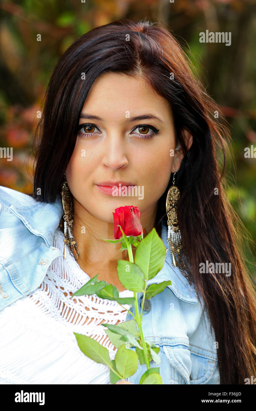 Beautiful brunette with red rose. Stock Photo