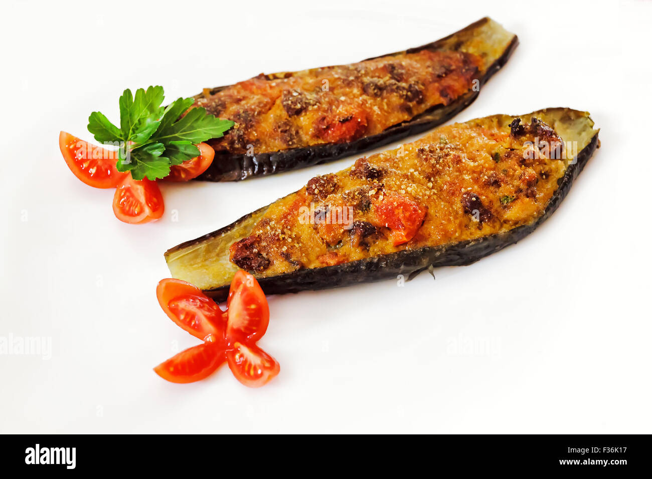 Two stuffed eggplant with meat, bread, tomato, capers, egg and bread
