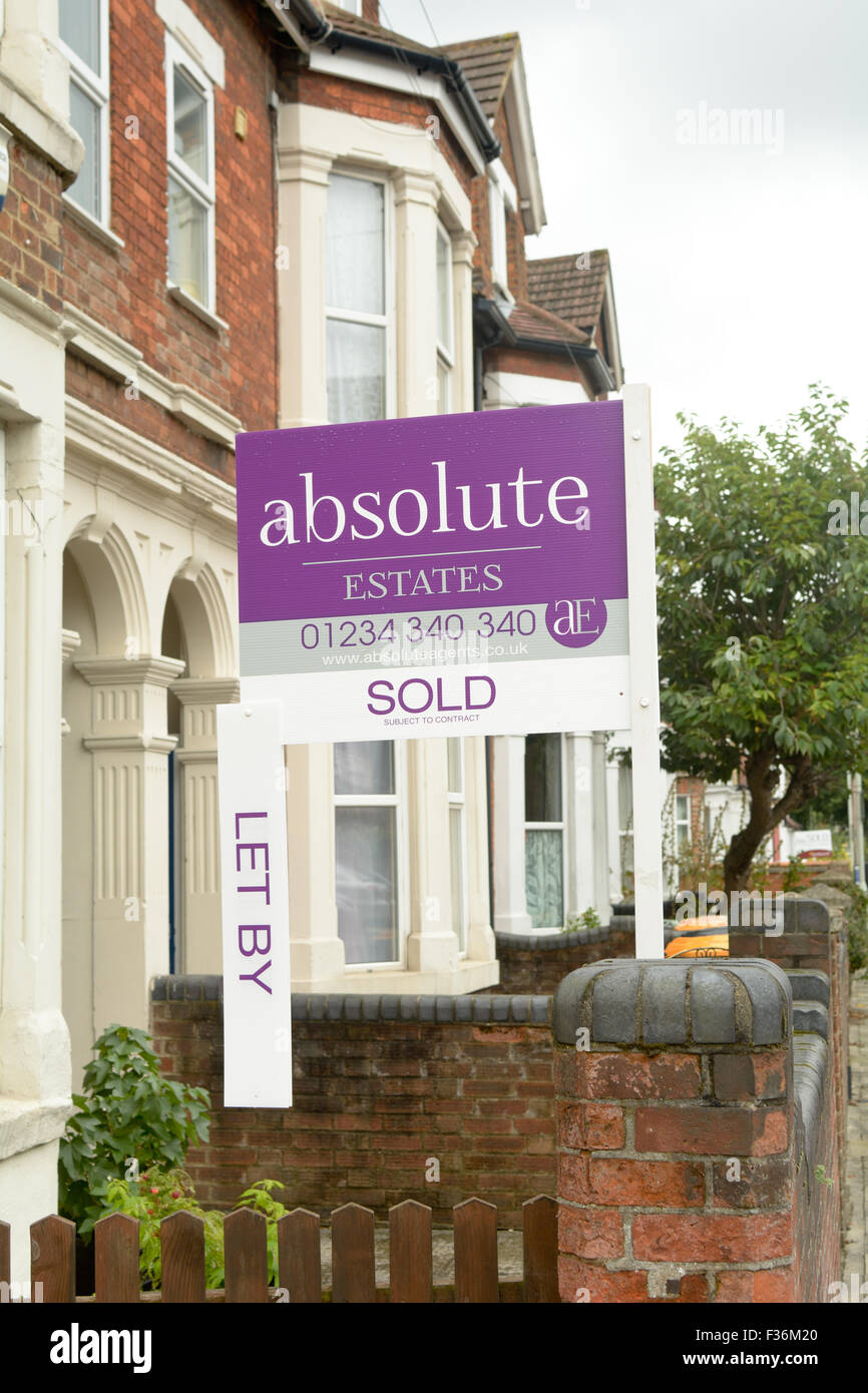 Absolute Estates estate agents Let by sign hanging off exposing Sold