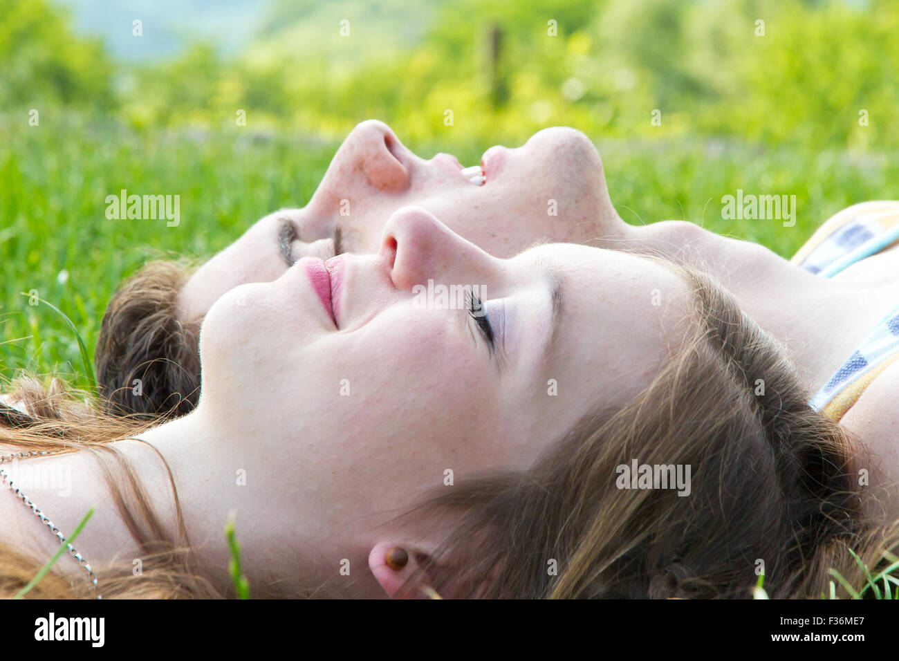 Happy, young couple lying on a meadow Stock Photo