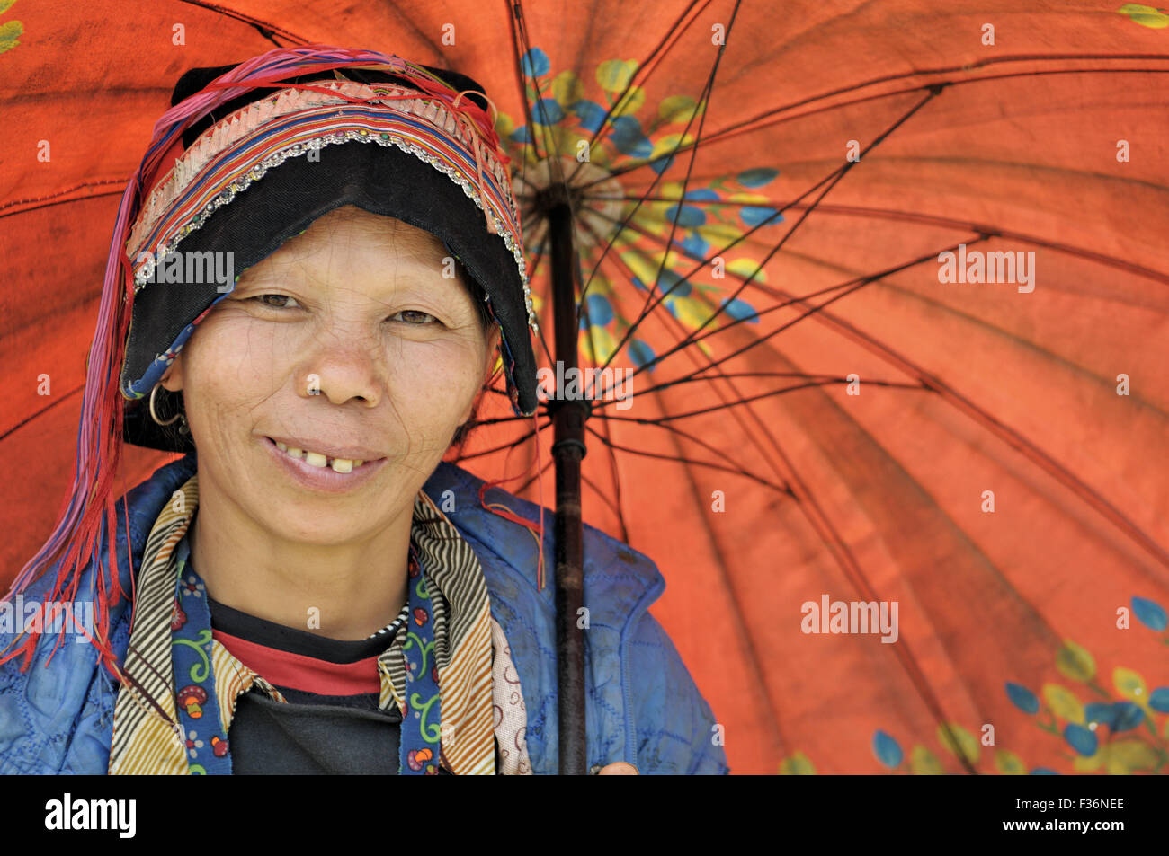 Dao woman under a colorful umbrella in Quyet Tien, Ha Giang province, Vietnam Stock Photo