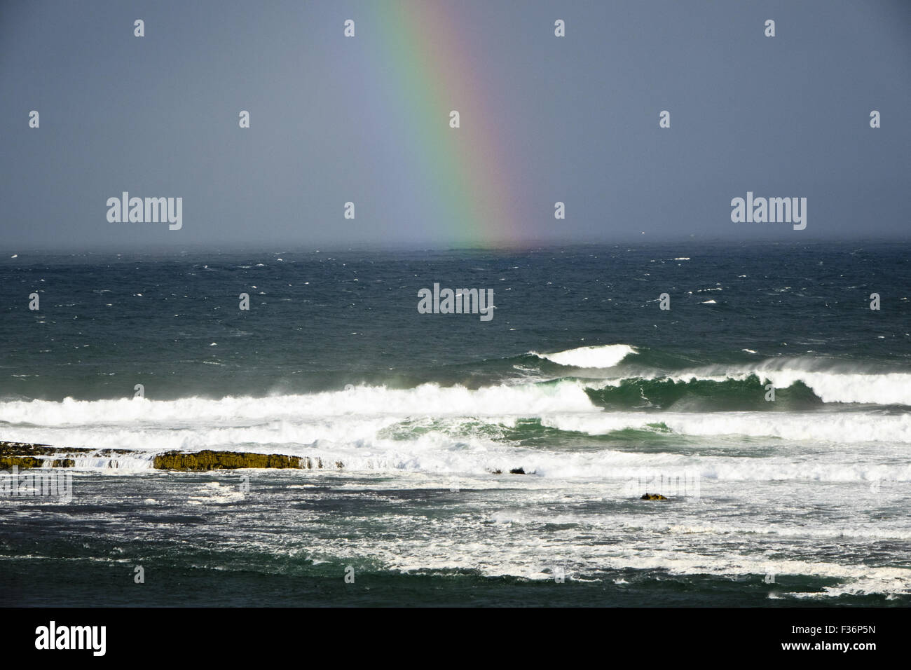 rainbow over Atlantic sea waves Stock Photo