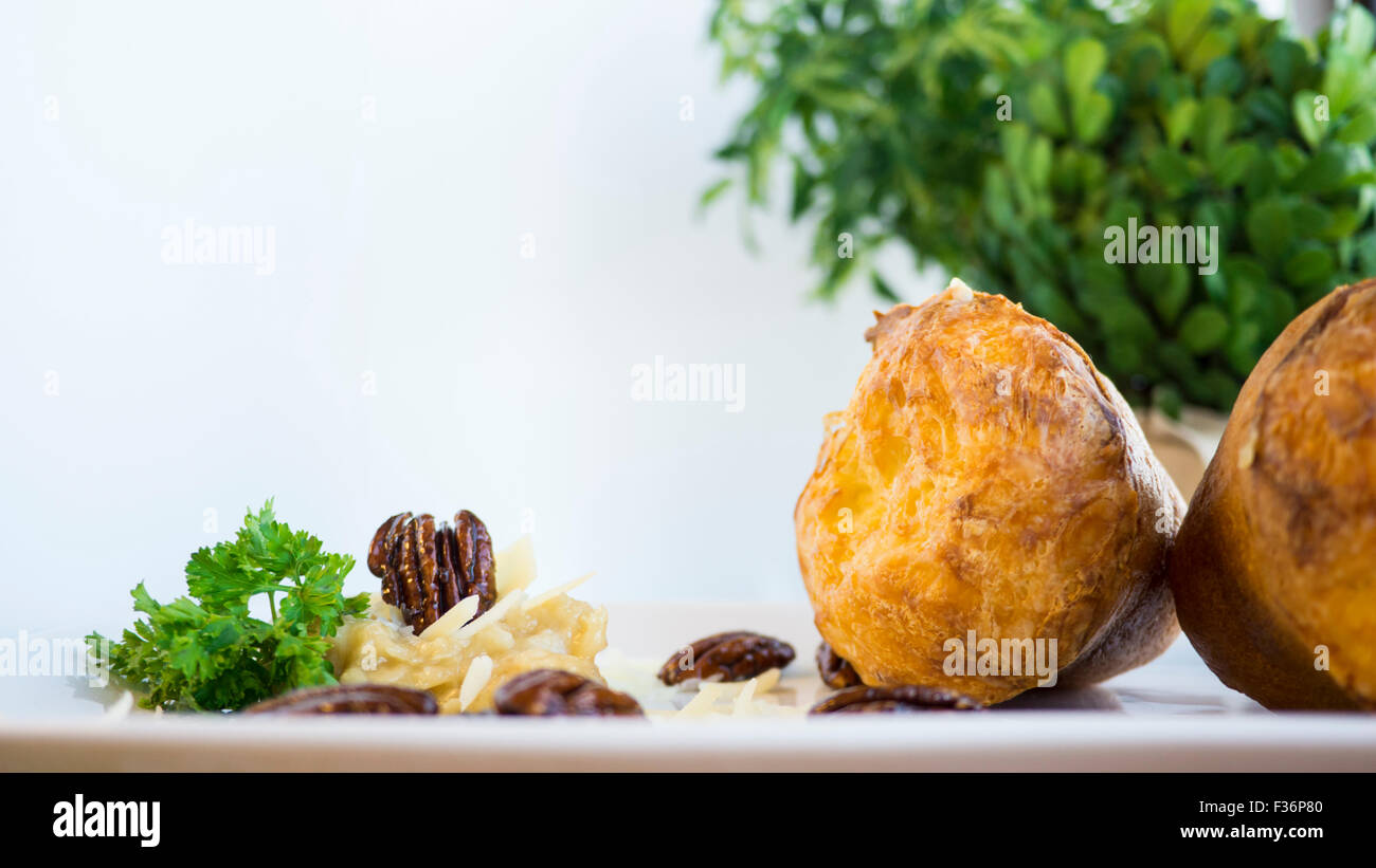 Savory gruyere popovers with garlic and candied walnuts Stock Photo