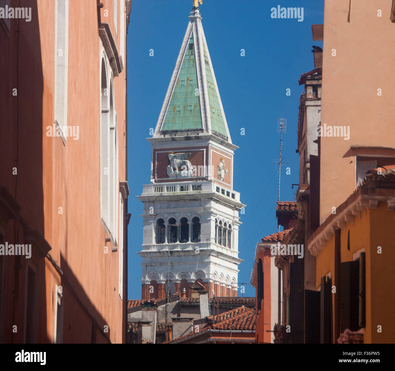 San Marco St Mark's Campanile seen between houses buildings on Rio San Salvador Venice Veneto Italy Stock Photo