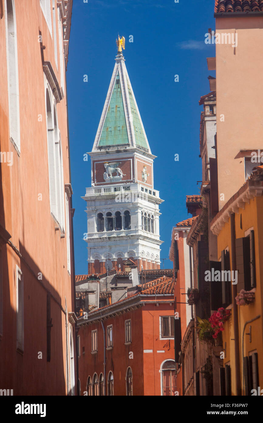 Campanile of San Marco St Mark's Basilica seen between buildings houses along Rio San Salvador Venice Veneto Italy Stock Photo