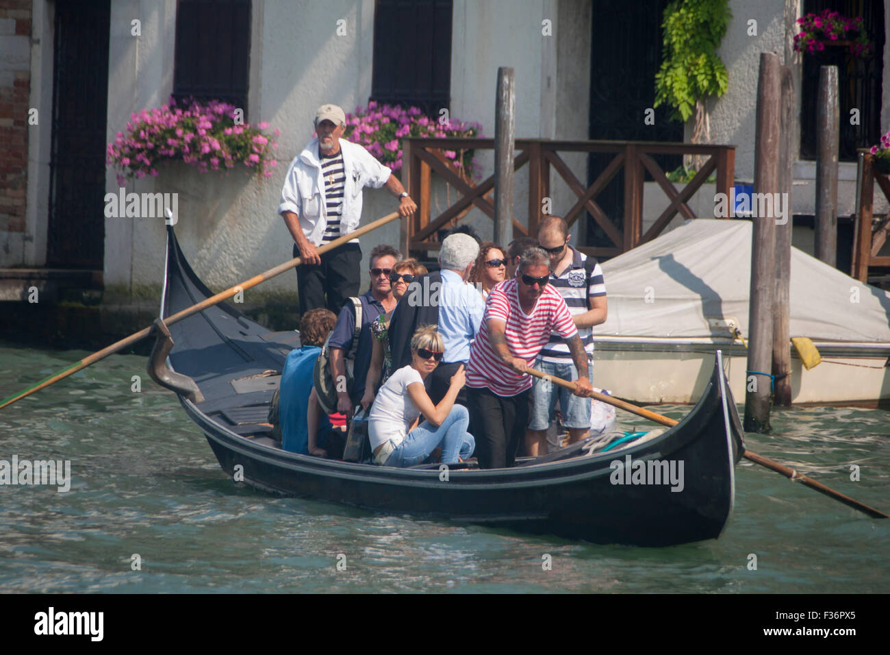 Traghetto full of passengers crossing Grand Canal to San Toma Venice Veneto Italy Stock Photo