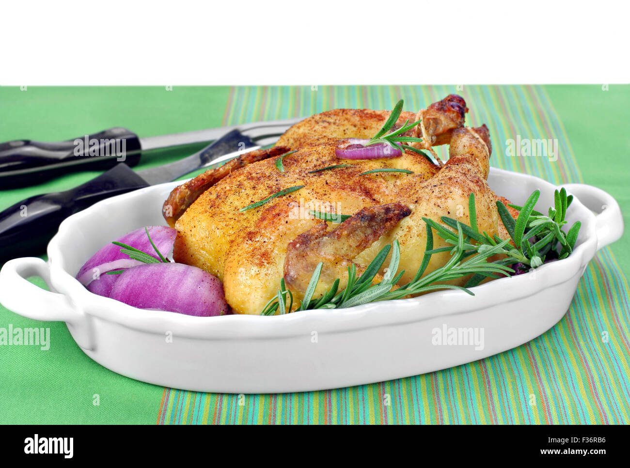 Roast chicken hen with fresh Rosemary and red onions for garnish. Copy