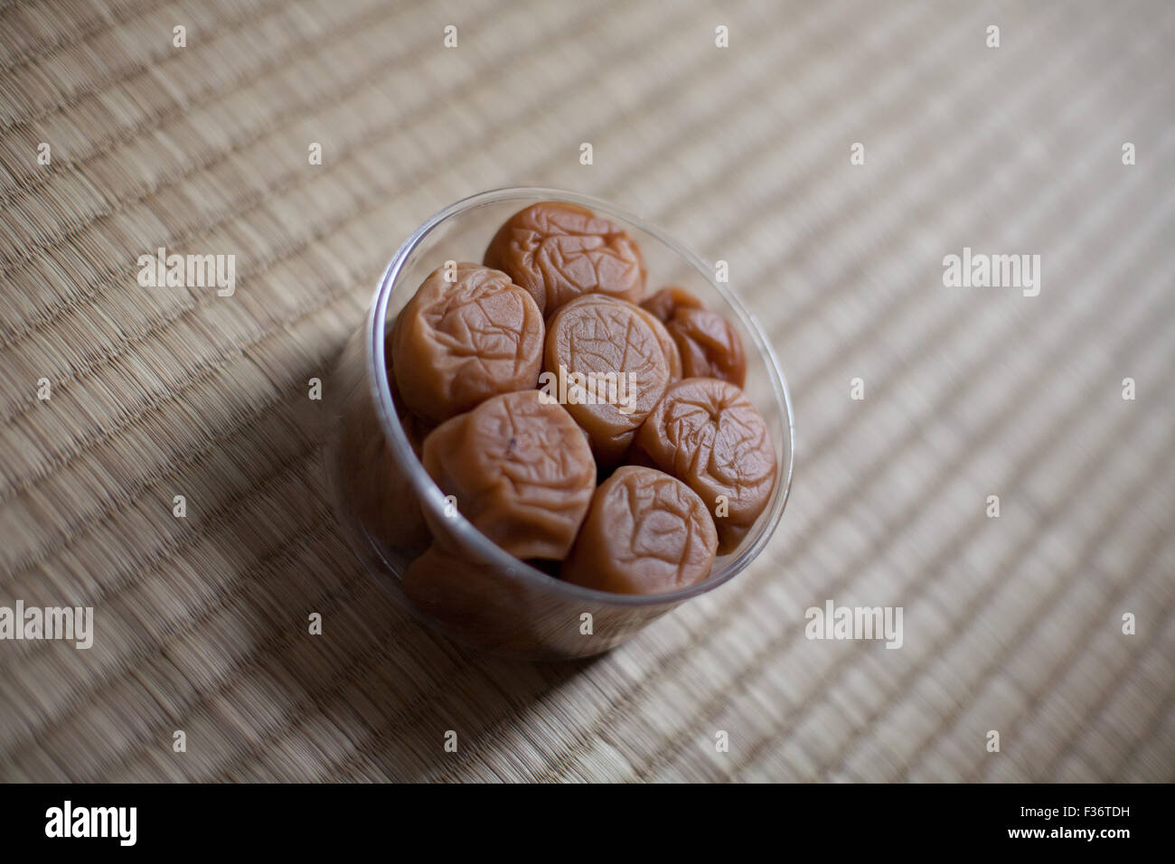 Umeboshi ume Japanese dried pickled salty plum tilted Stock Photo Alamy