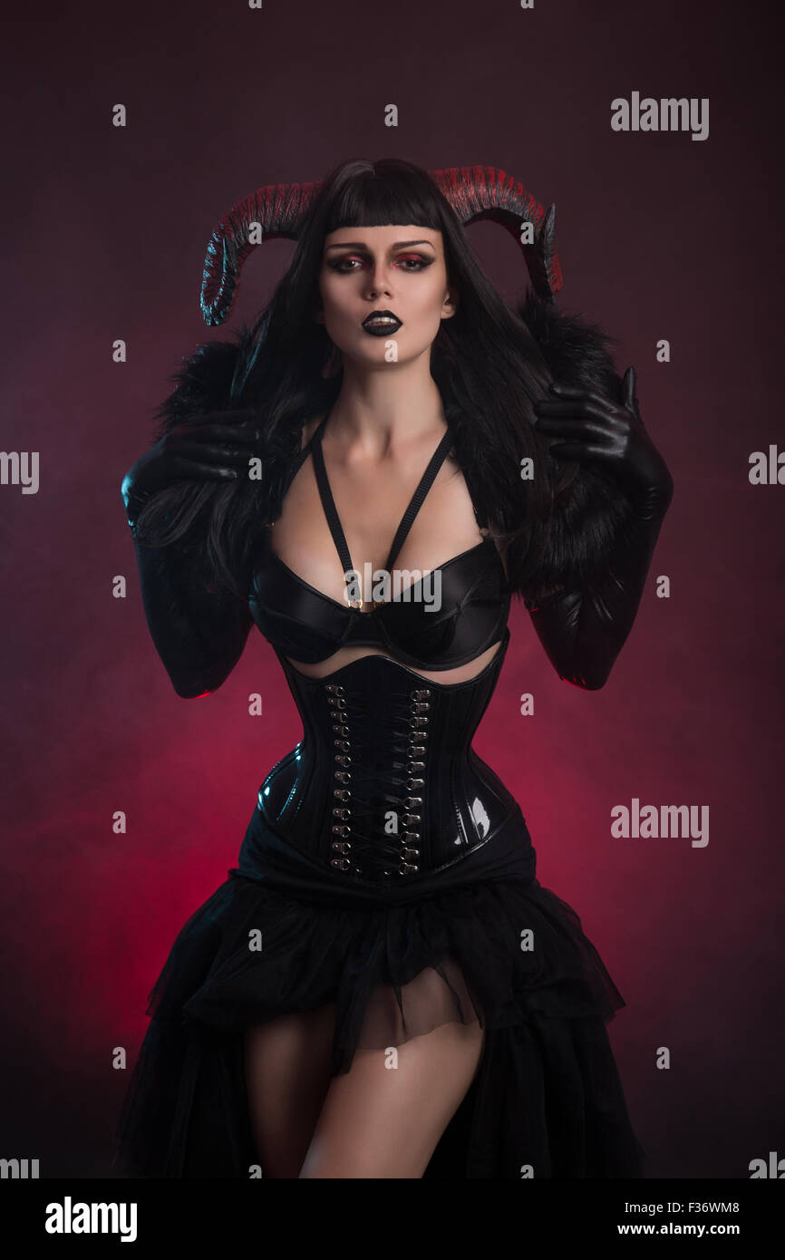Sexy female demon in fetish costume, Halloween theme Stock Photo