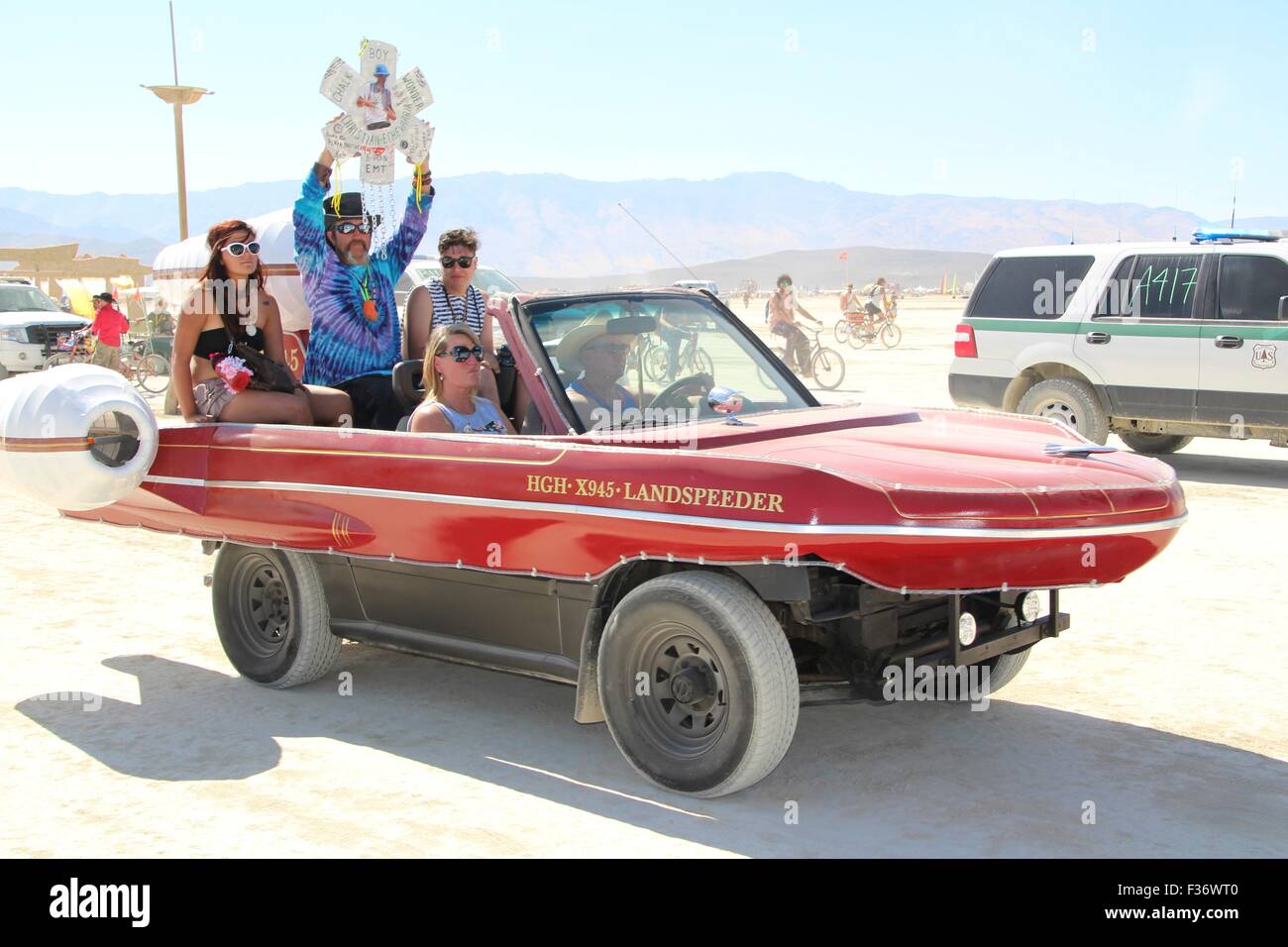 Burners ride an ampibcar in the playa during the annual Burning Man festival in the desert August 27, 2014 in Black Rock City, Nevada. Stock Photo
